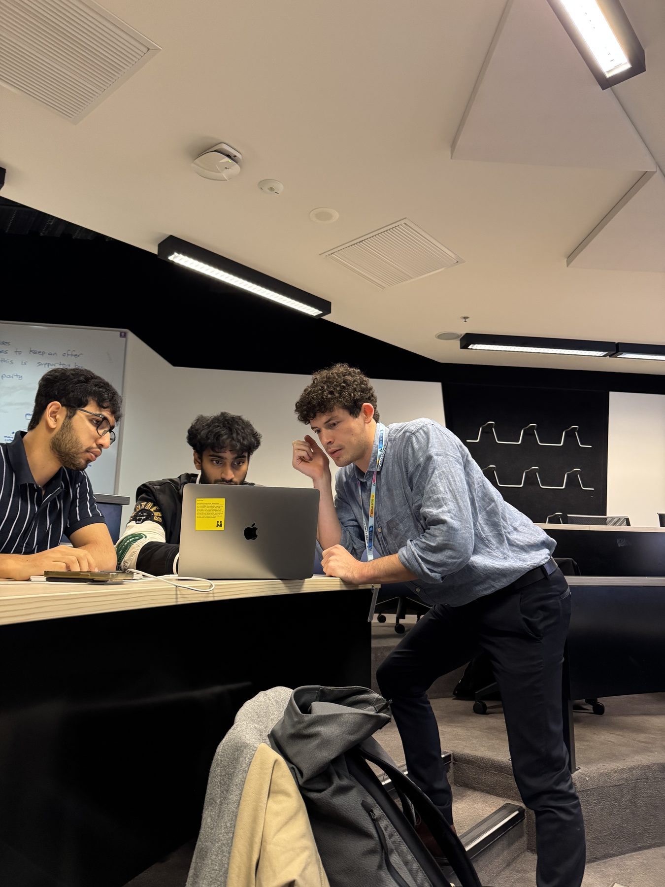 Noah working through a problem with colleagues