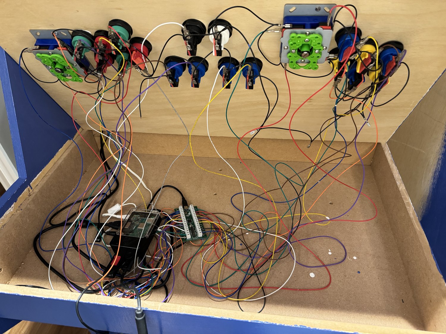 Wiring the joysticks and buttons to the controller board during the build