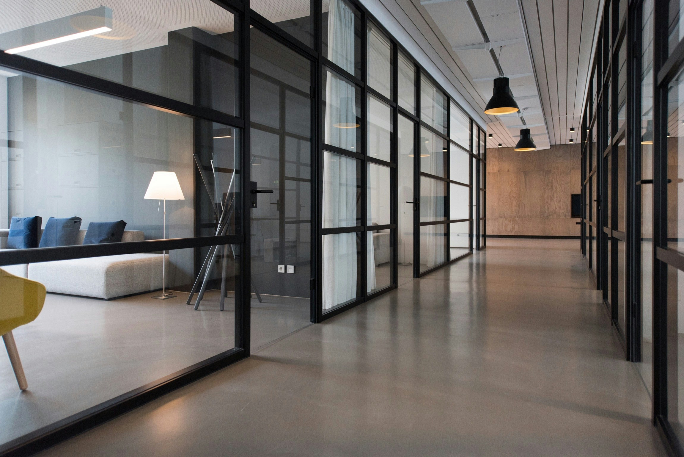 A calm, modern office interior with glass-partitioned rooms