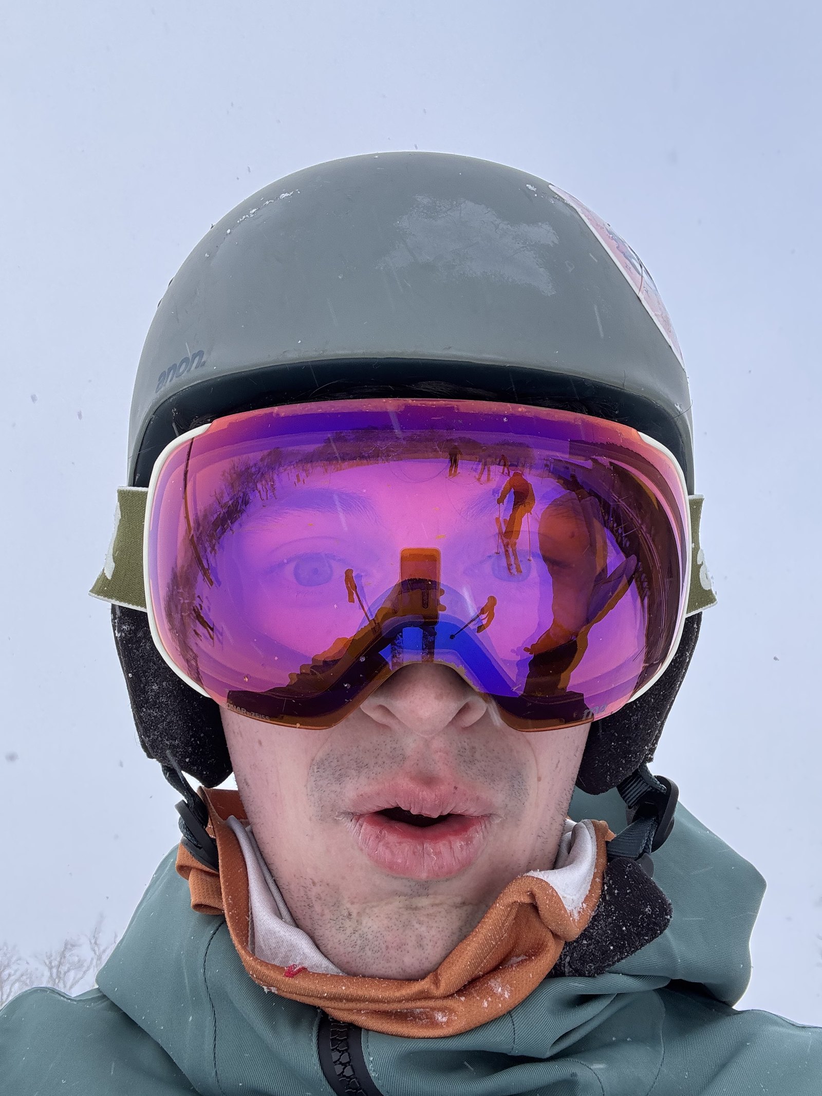 Noah in ski helmet and mirrored goggles on a snowy day in Niseko