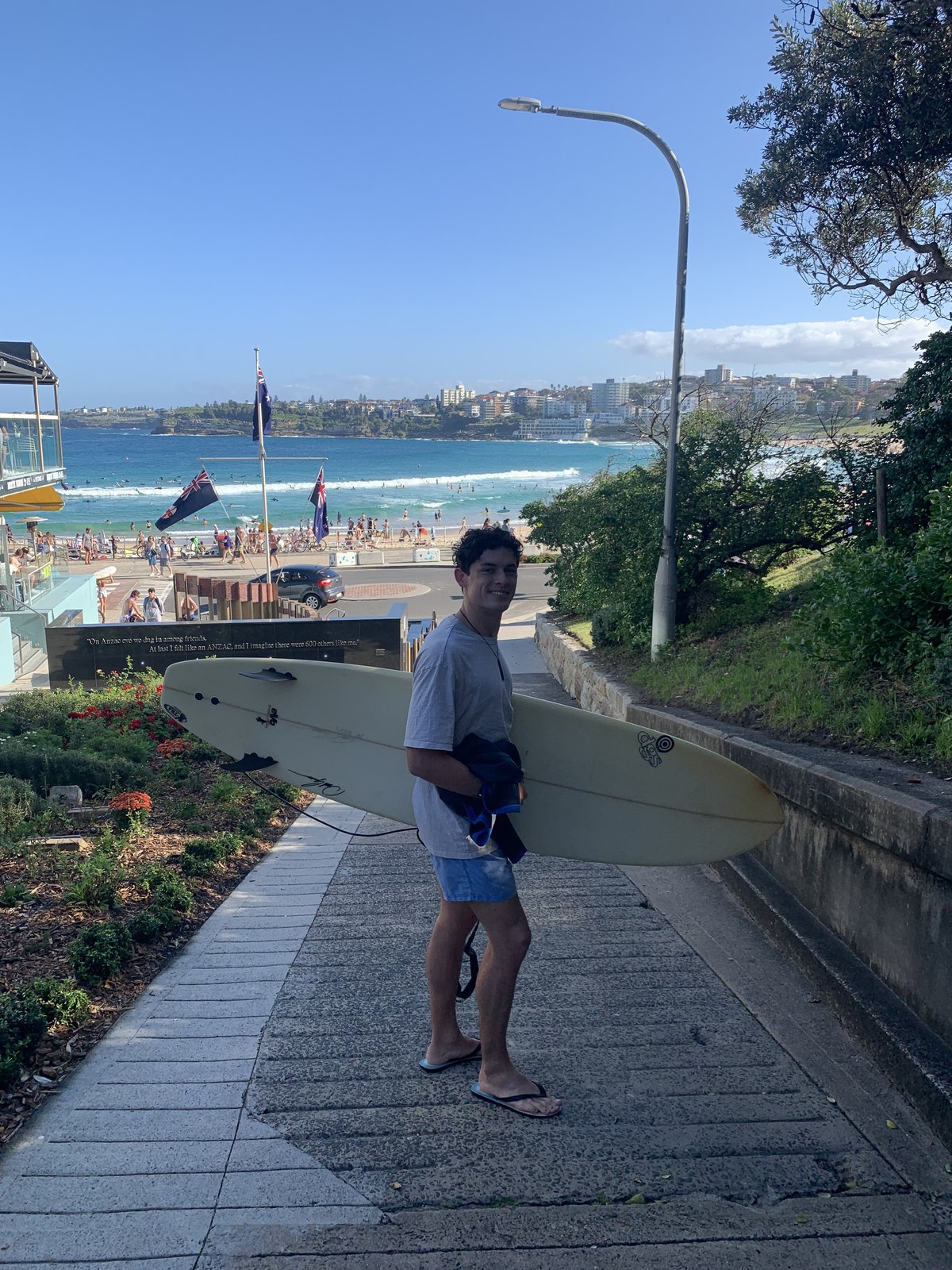 Noah carrying his surfboard down to a Sydney beach