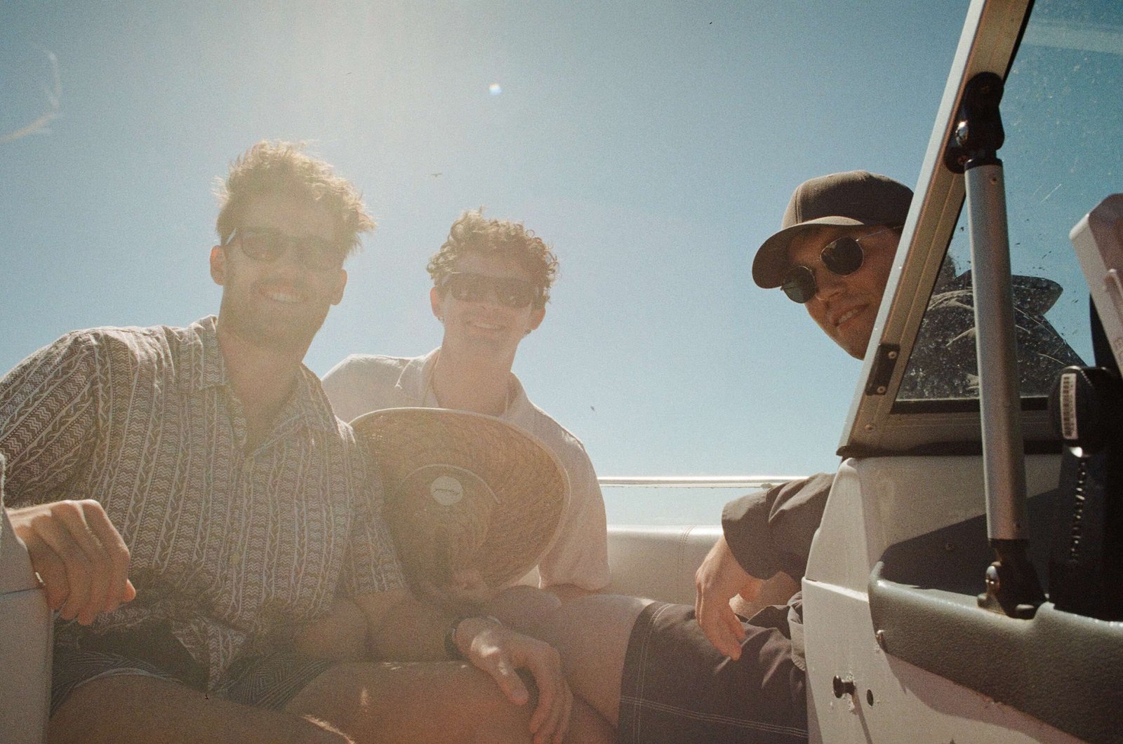 Noah and two friends out on a boat on a sunny day