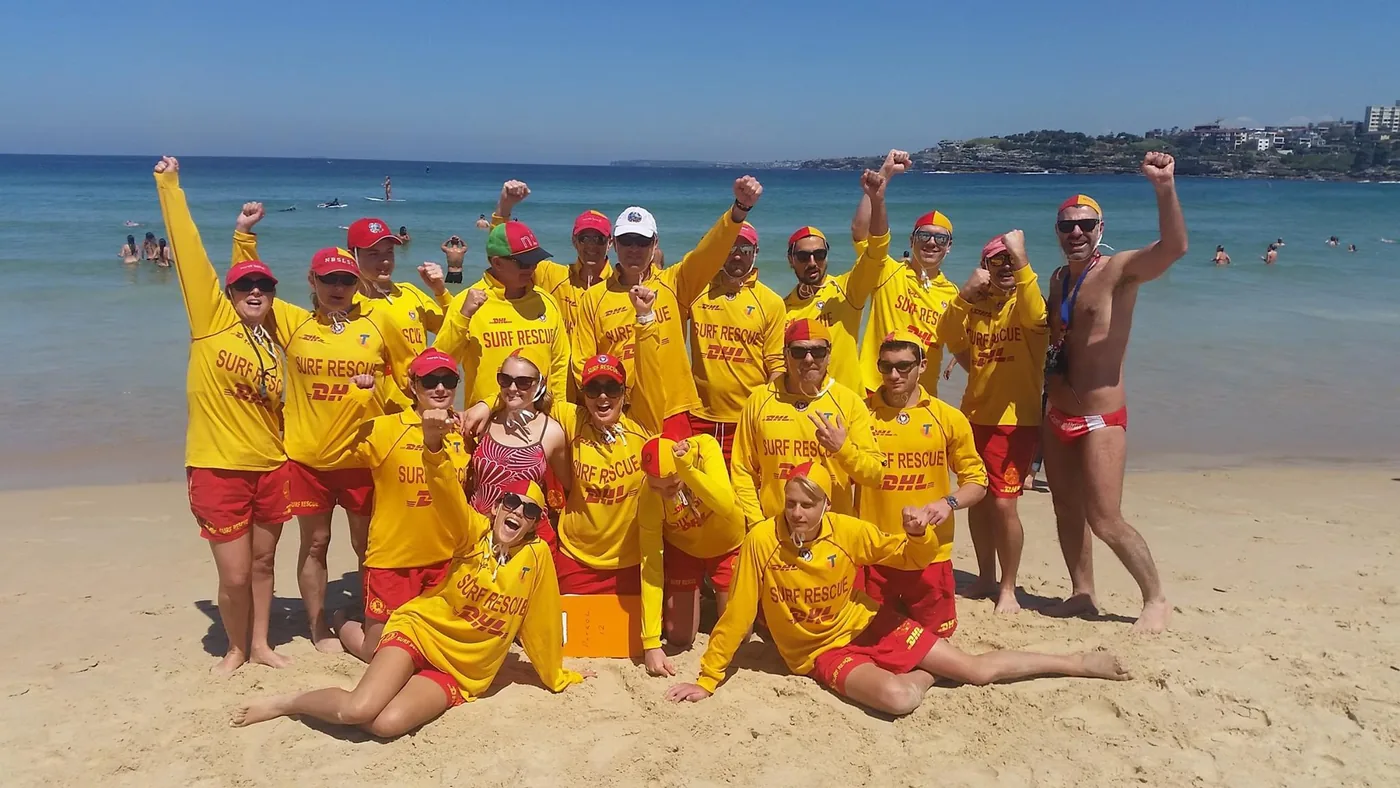 North Bondi Surf Life Saving Club patrol team in Surf Rescue yellow and red on the sand at Bondi Beach